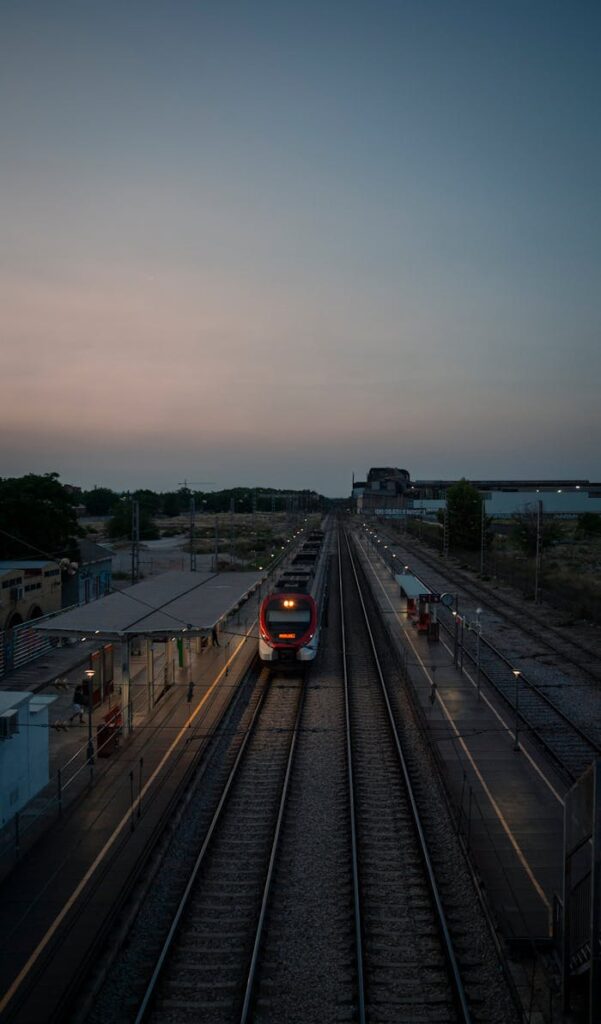 A train is traveling down a track at dusk